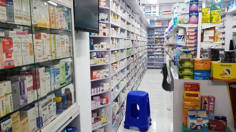 An aisle inside MIR Pharmacy, shelves stocked from floor to ceiling