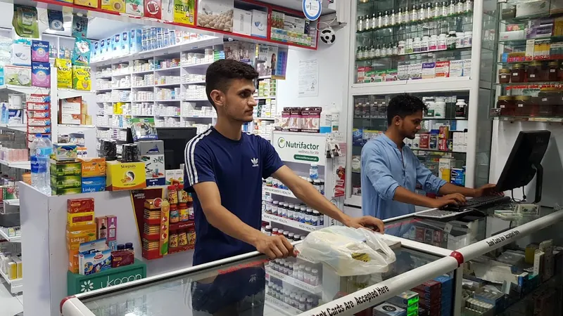The counter inside MIR Pharmacy, with shelves of medicines behind it