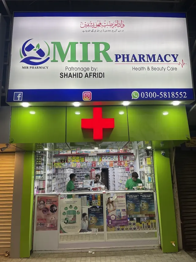 MIR Pharmacy shopfront by day, with the white sign and red cross over the entrance